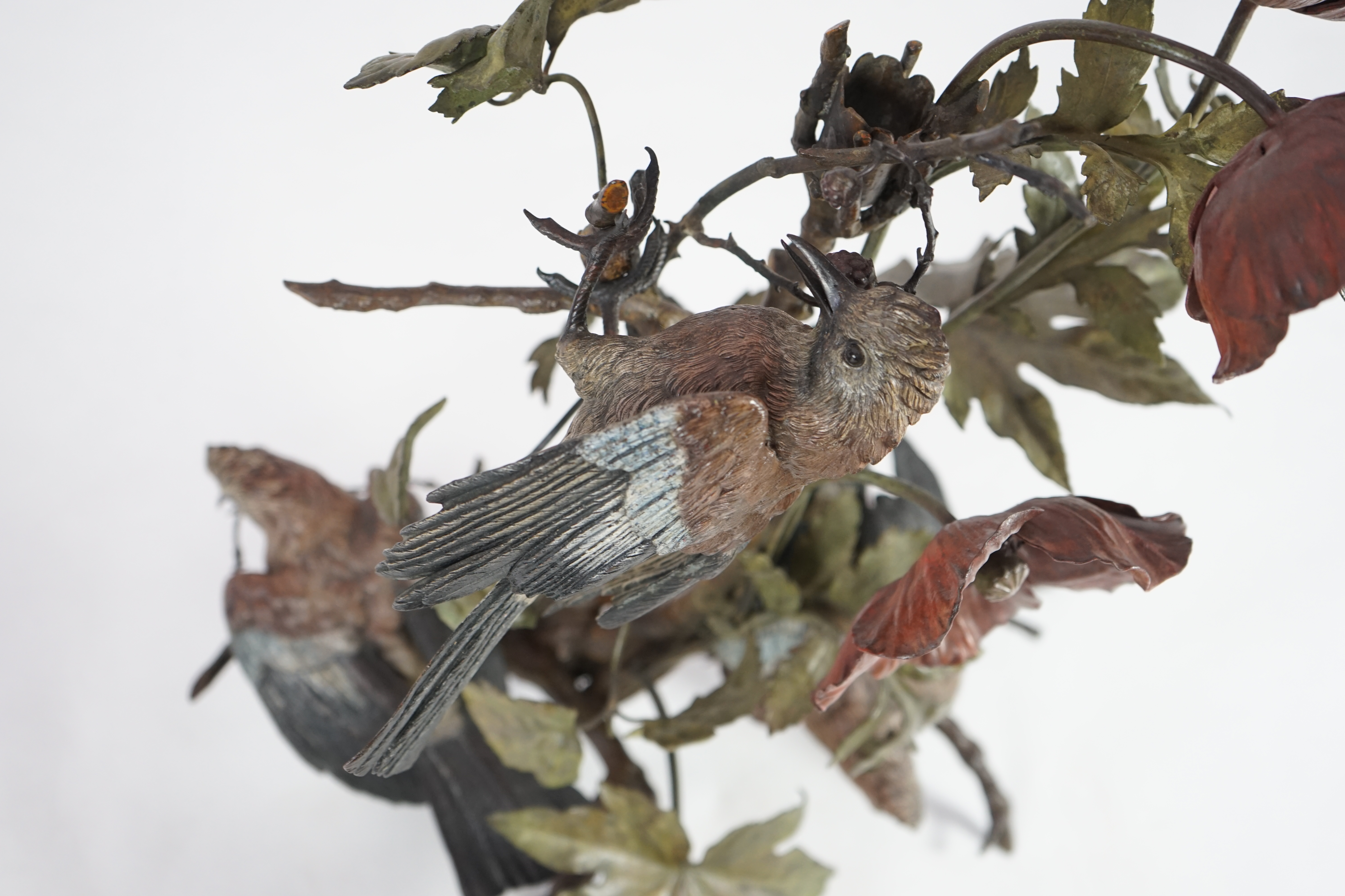 An impressive late 19th century Austrian cold painted bronze group of three jays perched amongst branches